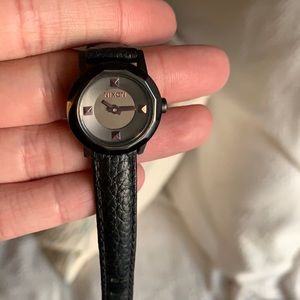 Women’s black leather Nixon watch.